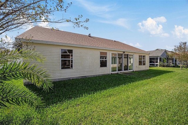 back of house featuring a lawn