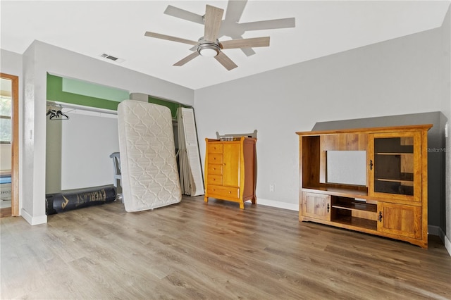 unfurnished living room featuring hardwood / wood-style floors and ceiling fan