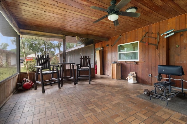 sunroom featuring wood ceiling and ceiling fan