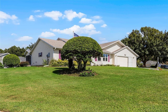 view of front of property with a front yard and a garage