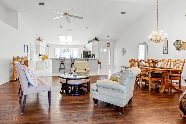 living room with a textured ceiling, high vaulted ceiling, hardwood / wood-style floors, and ceiling fan