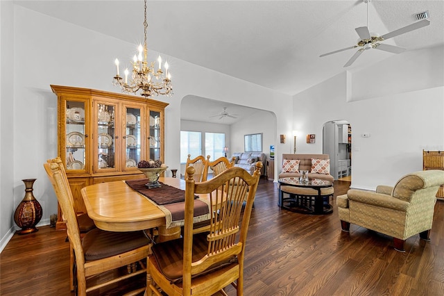 dining space with ceiling fan with notable chandelier, dark wood-type flooring, a textured ceiling, and high vaulted ceiling