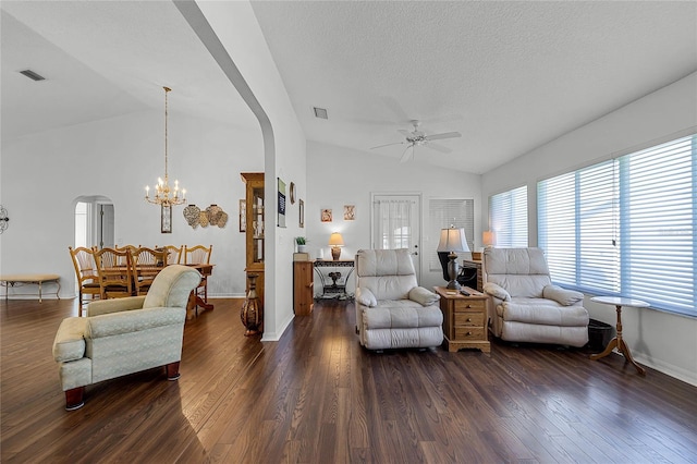 living room featuring dark wood-type flooring, arched walkways, visible vents, and vaulted ceiling