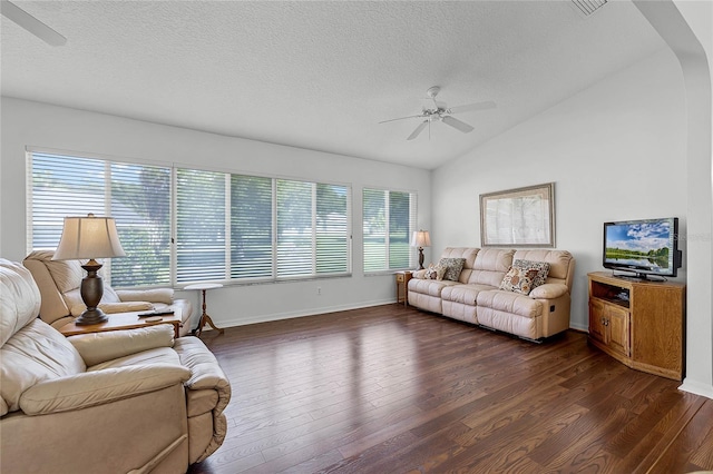 living room featuring vaulted ceiling, a wealth of natural light, ceiling fan, and dark hardwood / wood-style floors