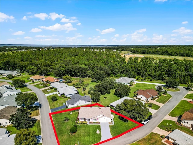 birds eye view of property featuring a wooded view and a residential view