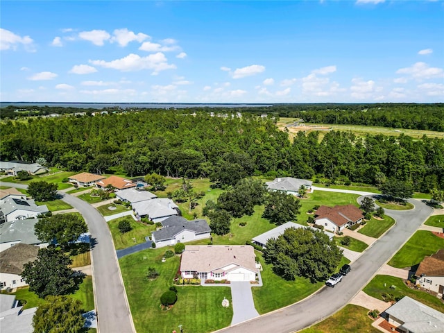 birds eye view of property with a residential view and a view of trees