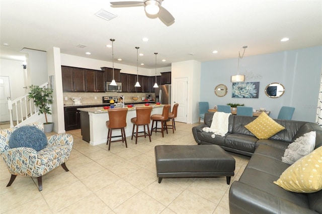 tiled living room featuring ceiling fan