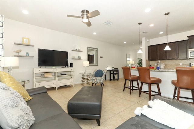 living room with ceiling fan and light tile patterned floors