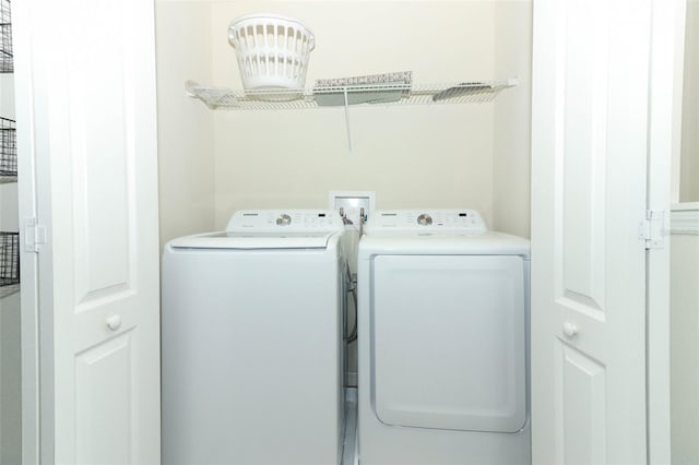 clothes washing area with washing machine and clothes dryer