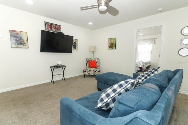 carpeted living room with ceiling fan