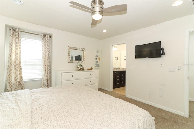 carpeted bedroom with ceiling fan and connected bathroom