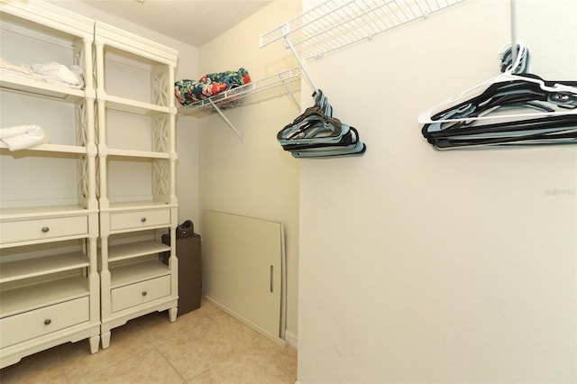 spacious closet featuring light tile patterned flooring