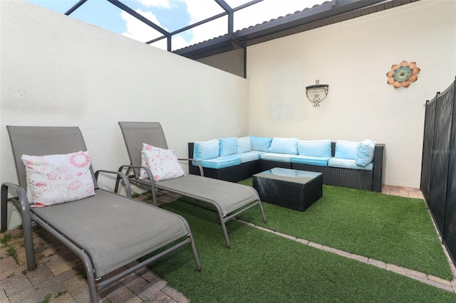 view of patio / terrace with an outdoor living space and glass enclosure