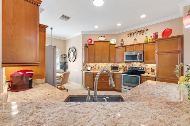 kitchen featuring decorative light fixtures, crown molding, sink, and appliances with stainless steel finishes