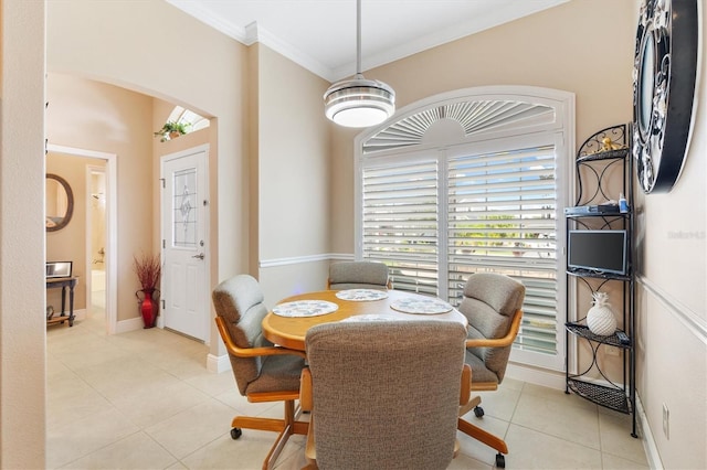 tiled dining area featuring ornamental molding