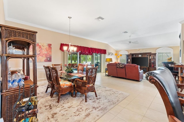 tiled dining room with ceiling fan with notable chandelier, crown molding, and vaulted ceiling