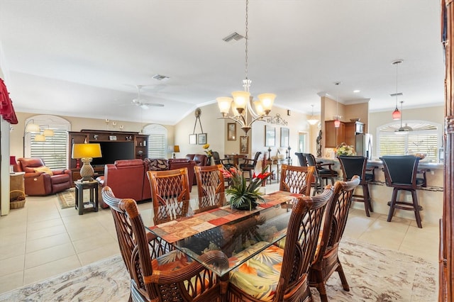 tiled dining room featuring vaulted ceiling, crown molding, and ceiling fan with notable chandelier