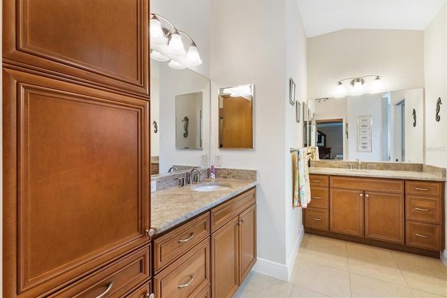 bathroom featuring tile patterned flooring, vanity, and lofted ceiling