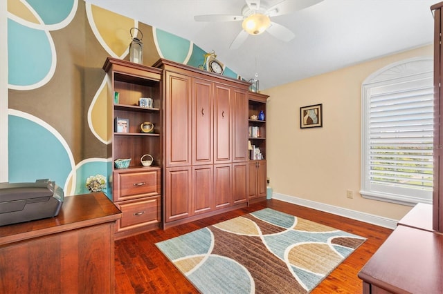 home office featuring vaulted ceiling, ceiling fan, and dark wood-type flooring