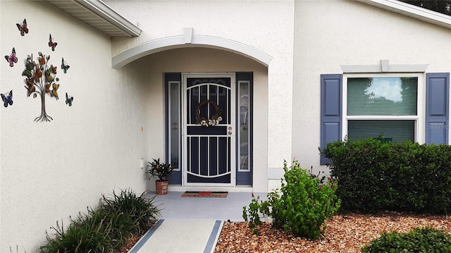 doorway to property with stucco siding