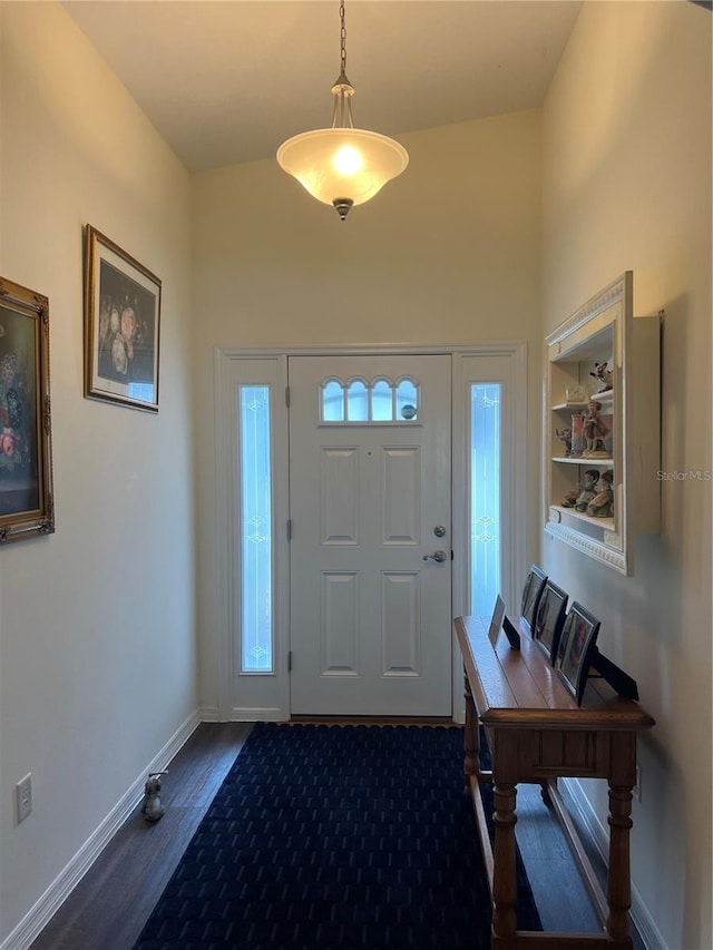 foyer entrance with baseboards and dark wood-style flooring