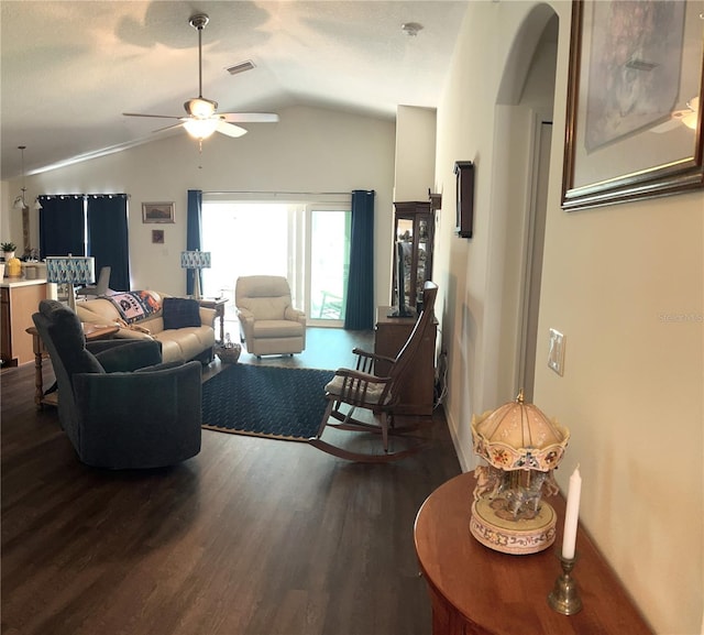 living room with arched walkways, ceiling fan, dark wood-type flooring, and lofted ceiling