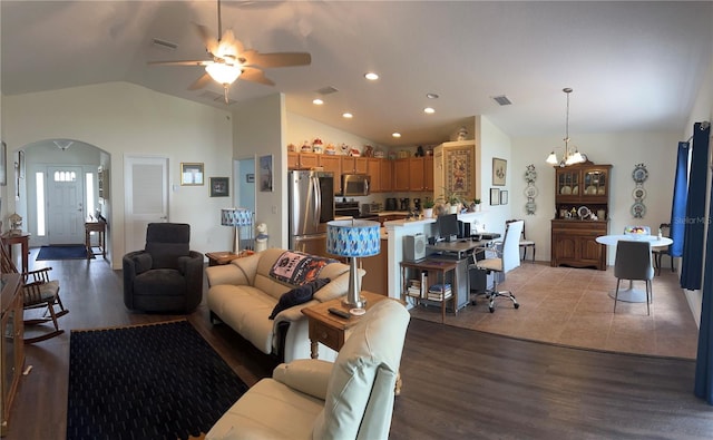 living area featuring lofted ceiling, light wood-type flooring, visible vents, and arched walkways