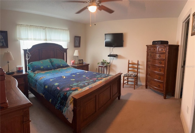 bedroom with light carpet and a ceiling fan