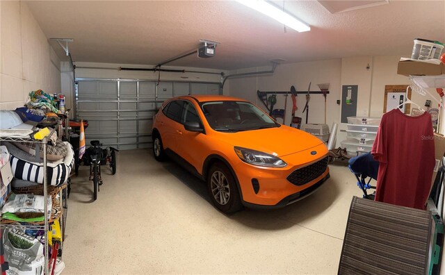 garage with electric panel and a garage door opener