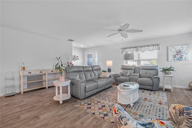 living room with ceiling fan and hardwood / wood-style flooring