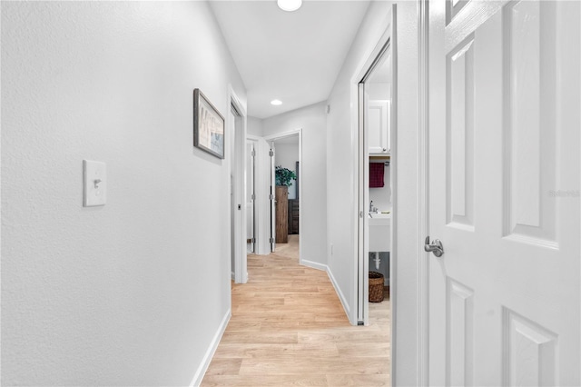 corridor featuring light hardwood / wood-style floors