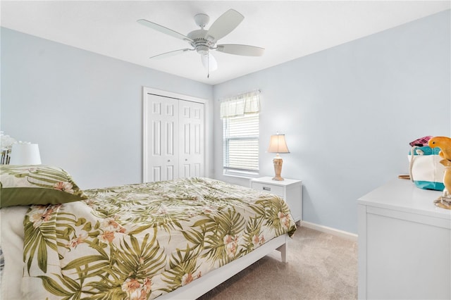 carpeted bedroom with a closet and ceiling fan