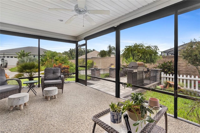 sunroom / solarium featuring ceiling fan