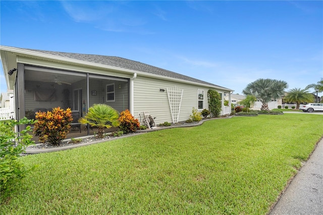 view of side of home with a lawn