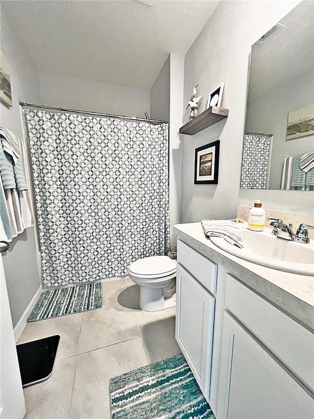 bathroom with vanity, tile patterned floors, toilet, a textured ceiling, and curtained shower