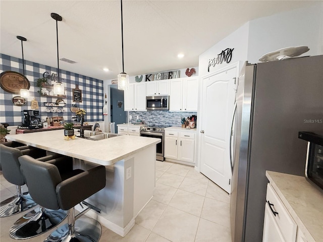 1771 Henin Cir, Tavares, FL 32778 - kitchen with light countertops, a sink, white cabinetry, appliances with stainless steel finishes, and wallpapered walls