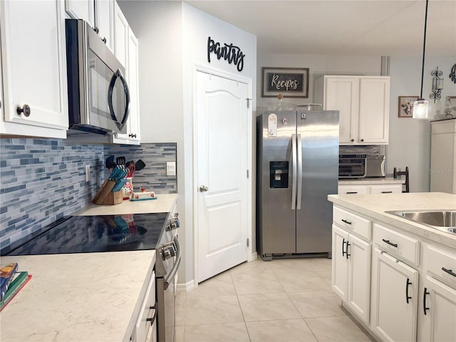 1771 Henin Cir, Tavares, FL 32778 - kitchen with white cabinetry, light countertops, and stainless steel appliances