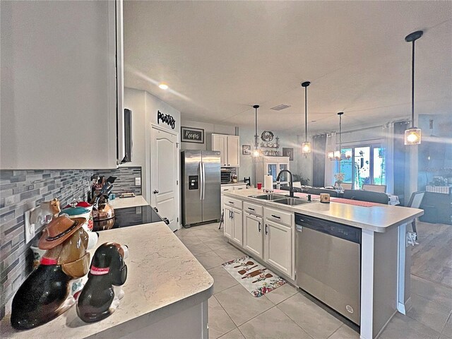 1771 Henin Cir, Tavares, FL 32778 - kitchen with light countertops, tasteful backsplash, a sink, white cabinets, and appliances with stainless steel finishes