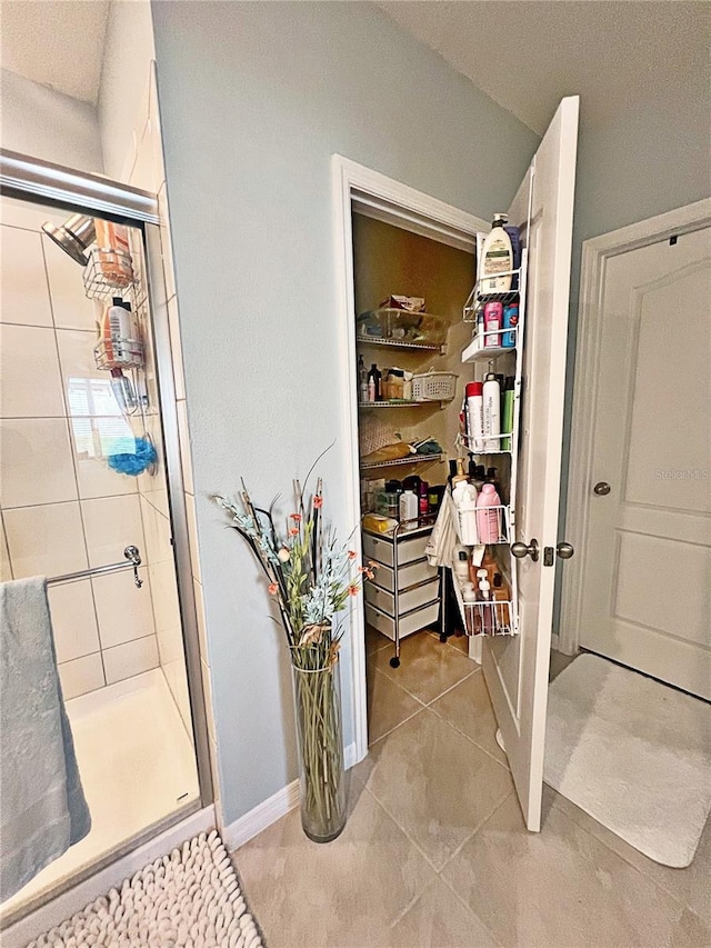 1771 Henin Cir, Tavares, FL 32778 - bathroom featuring baseboards, tile patterned flooring, and a shower stall