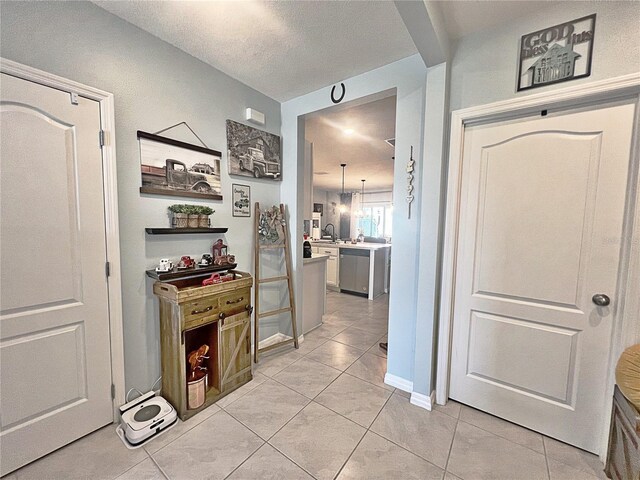 1771 Henin Cir, Tavares, FL 32778 - kitchen with dishwasher, light countertops, a sink, and light tile patterned floors