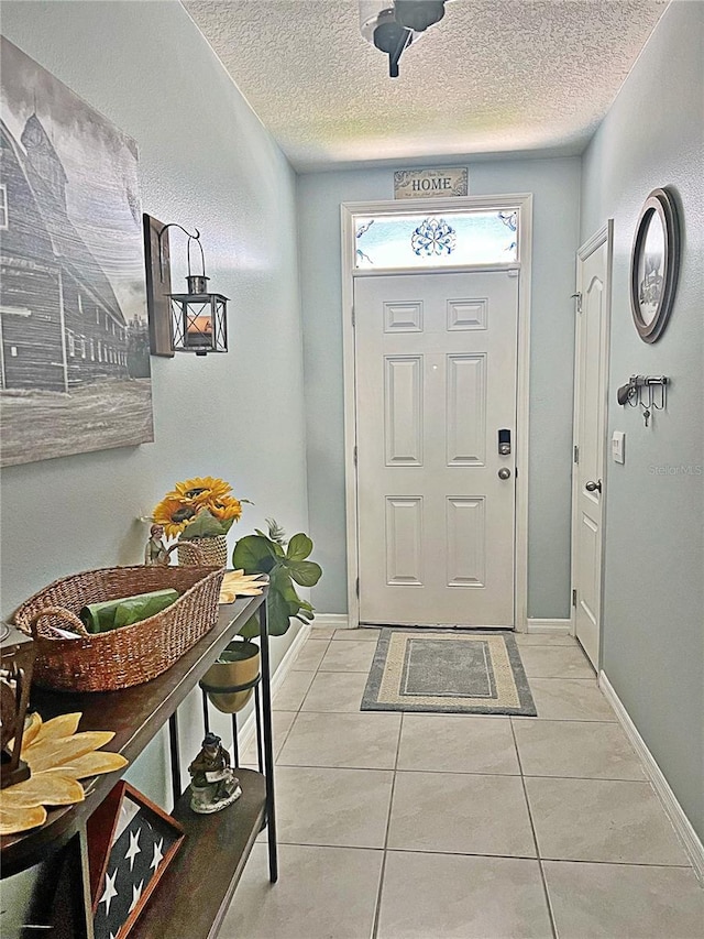 1771 Henin Cir, Tavares, FL 32778 - foyer entrance with baseboards, a textured ceiling, and light tile patterned floors