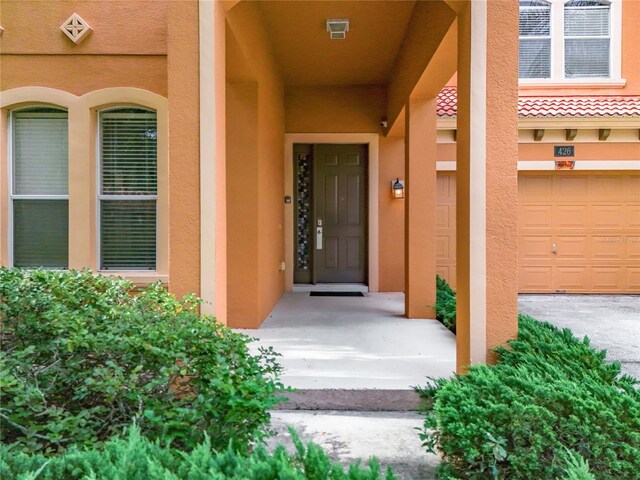 view of exterior entry with a garage