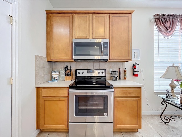 kitchen featuring a wealth of natural light, appliances with stainless steel finishes, and tasteful backsplash