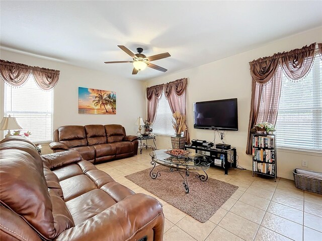 living room featuring ceiling fan, light tile patterned floors, and a healthy amount of sunlight