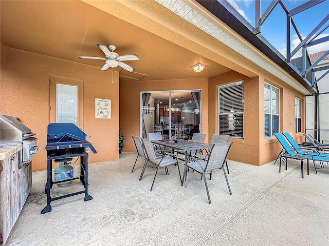 view of patio featuring grilling area, ceiling fan, and a lanai