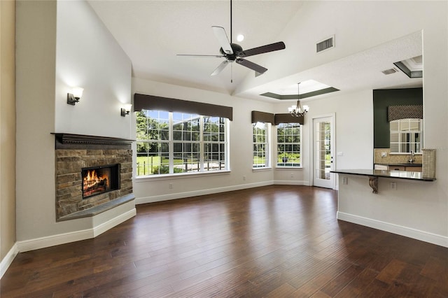 unfurnished living room with hardwood / wood-style flooring, baseboards, a fireplace, and visible vents