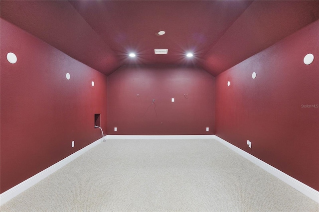 home theater room featuring lofted ceiling, carpet, baseboards, and recessed lighting