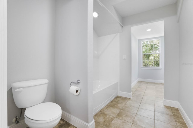 bathroom with tile patterned flooring, baseboards, and toilet