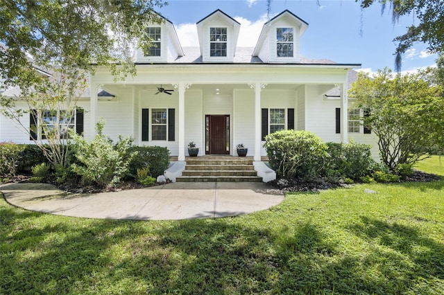 cape cod house with a front yard and ceiling fan