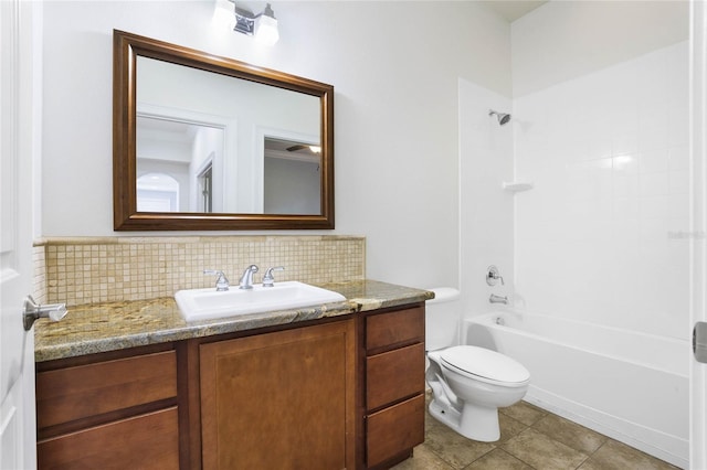 full bath with decorative backsplash, bathing tub / shower combination, toilet, tile patterned floors, and vanity